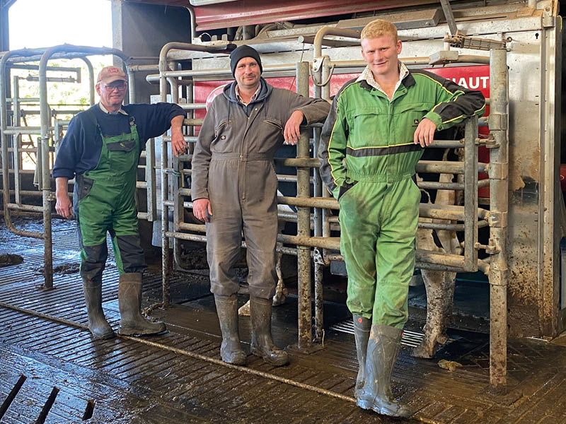 Mark, Denis and Lewis Tibbs in milking parlour
