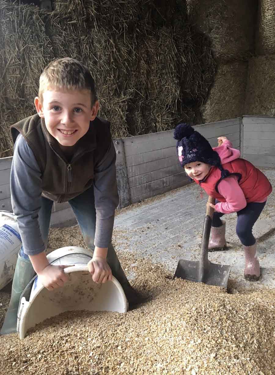 children shovelling grain
