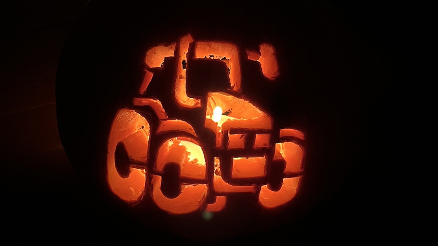 A tractor carved out into a lit-up pumpkin