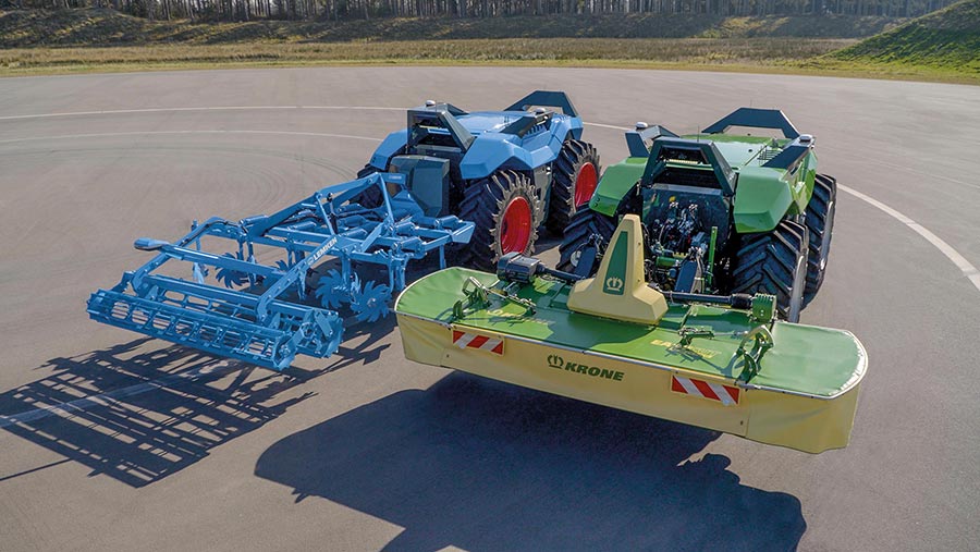 Two driverless tractor units with attachments