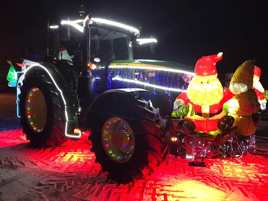 Tractor with red lighting and Santa figure on the front