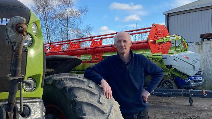 Farmer leaning on tractor tyre