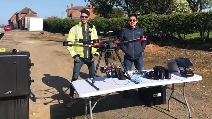 Researchers setting up a drone to monitor blackgrass