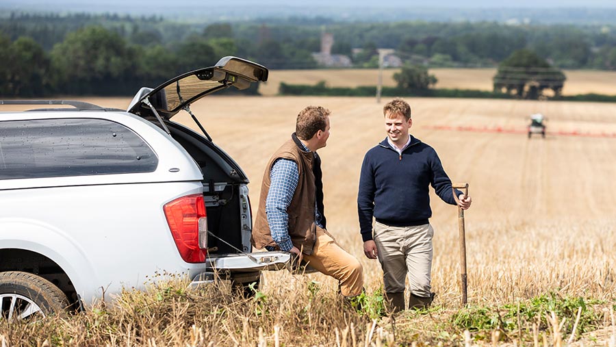 Two farmers chatting in a field