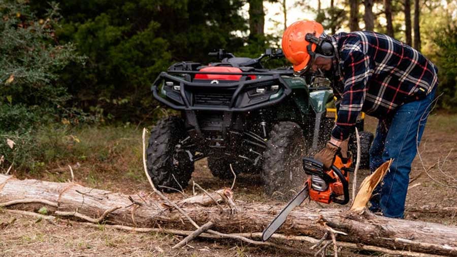 Can-Am quad with person sawing wood