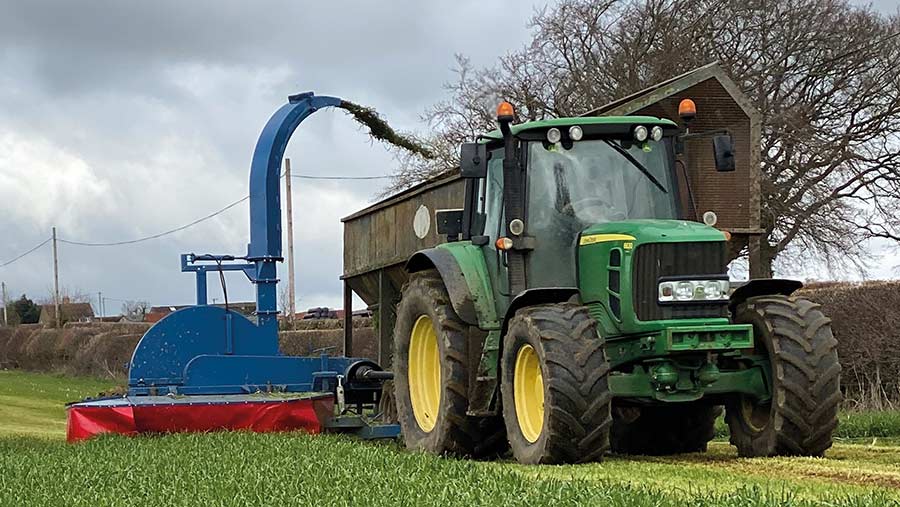 Tractor and zero grazer cutting grass