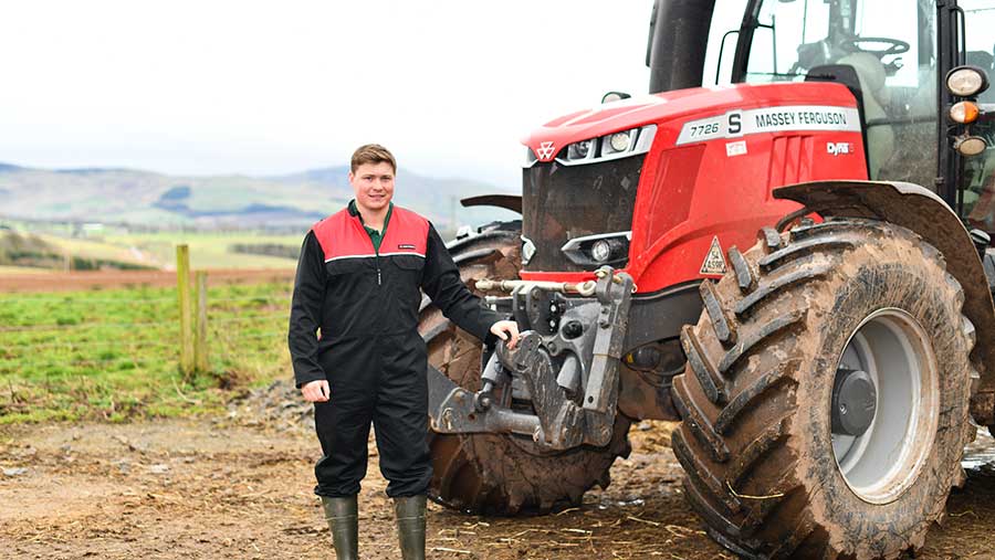 Matthew Douglas stood in front of a tractor