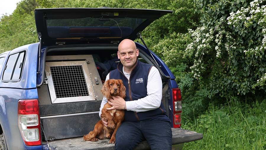 Male farmer posing with dog