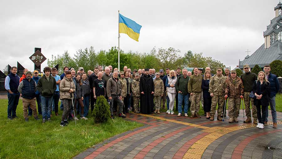 Group of farmers and soldiers with Ukrainian flag