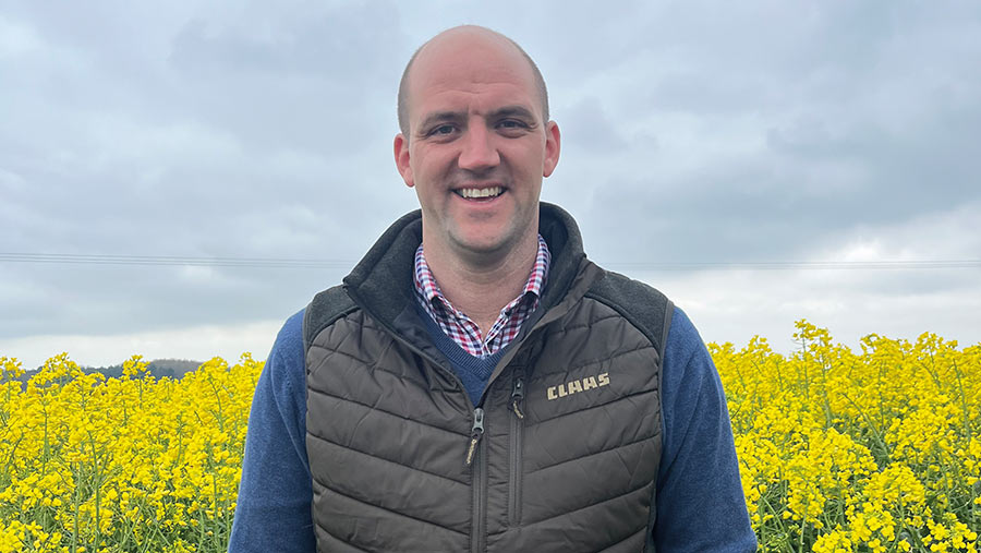 Farmer Will Baker stood in a field of oilseed rape