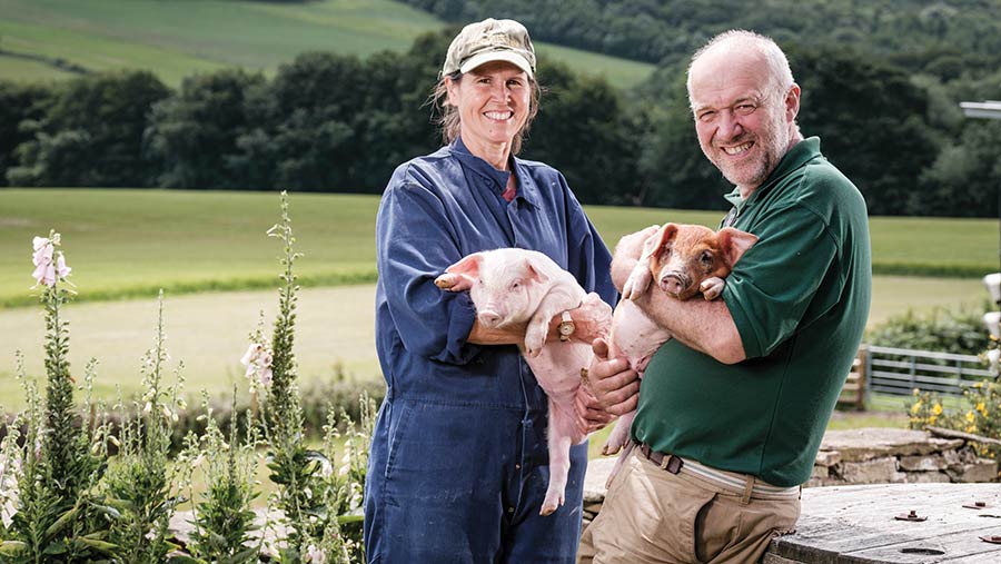 Karen and Stephen Thompson holding piglets