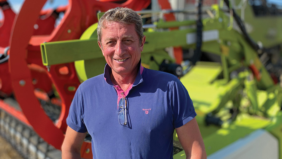 Man stood in front of combine header