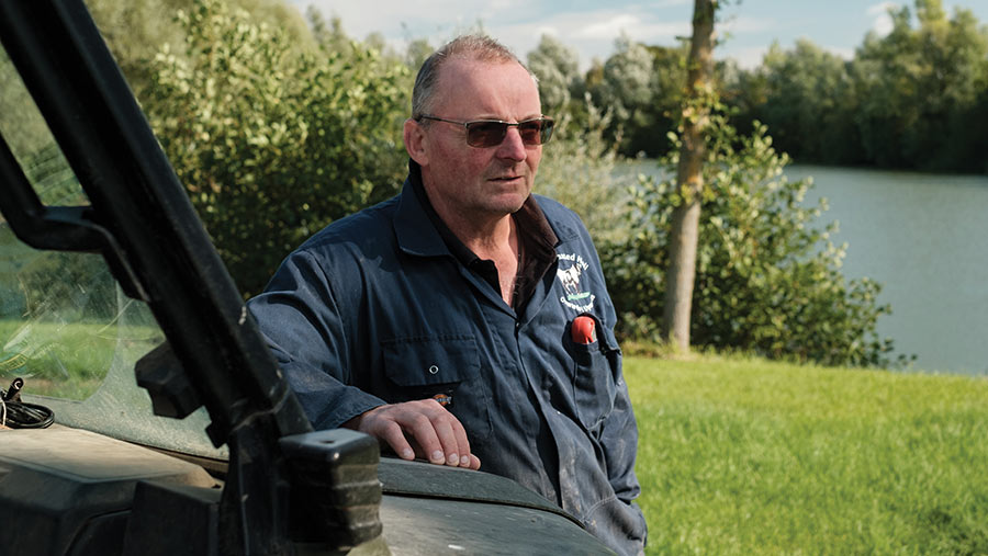 Farmer leaning on ATV