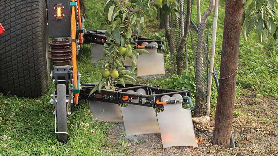 RootWave Top Fruit's suspended guide wheels in operation, keeping the electrodes at the correct height to maintain a good connection with the ground and target weeds 