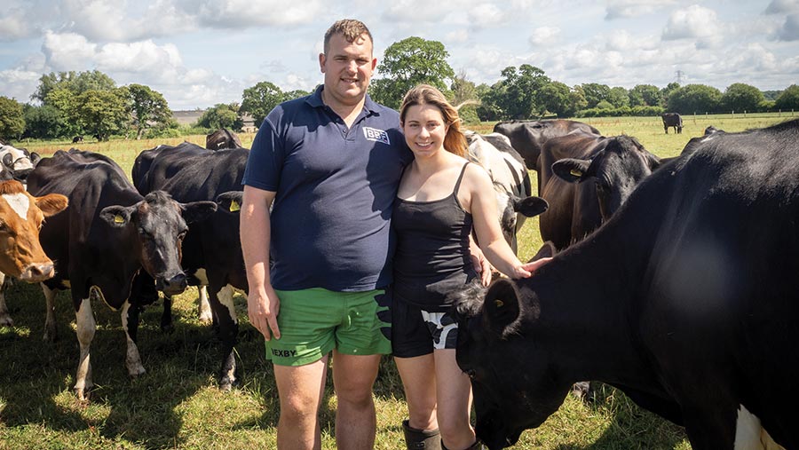 Two farmers stood with cows