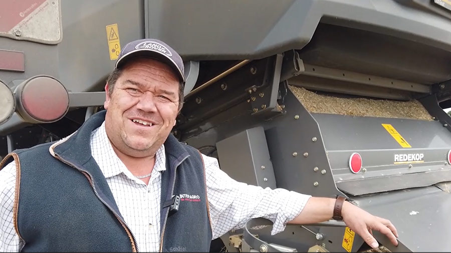 Farm manager standing next to a Redekop seed control unit (SCU) fitted to a Fendt Ideal 10T combine