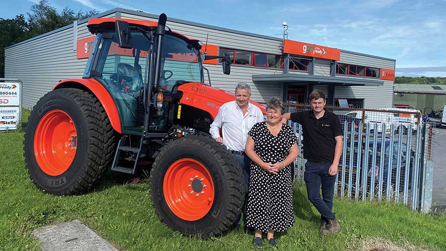 People in front of Kubota tractor