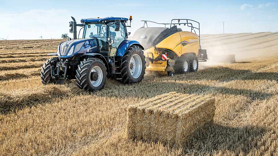 Tractor, baler and big square bale in a field