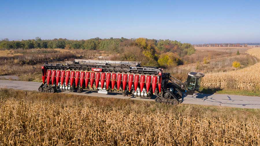 Nexat‘s all-in-one system tractor on a country road next to a field