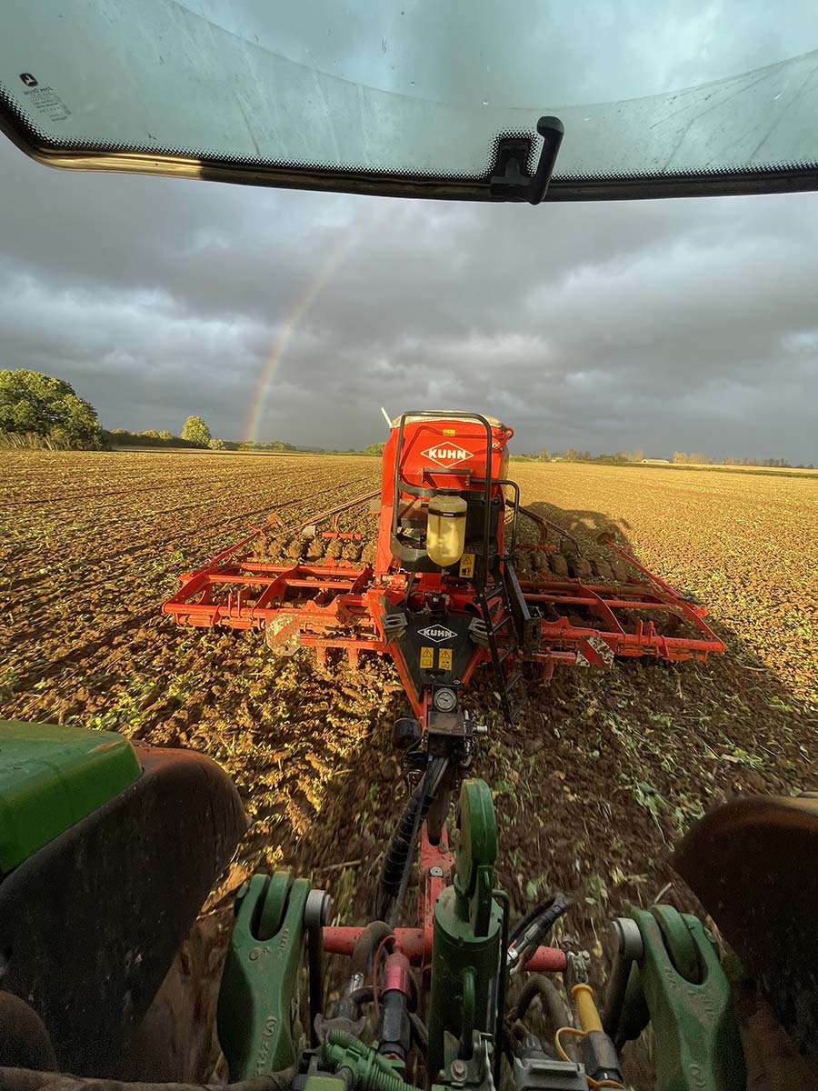 Wheat being drilled with rainbow in the s