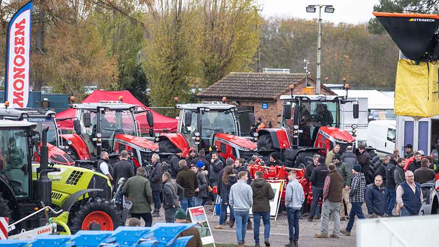 Crowds of attendees chatting and looking at tractors on display at the Midlands Machinery Show