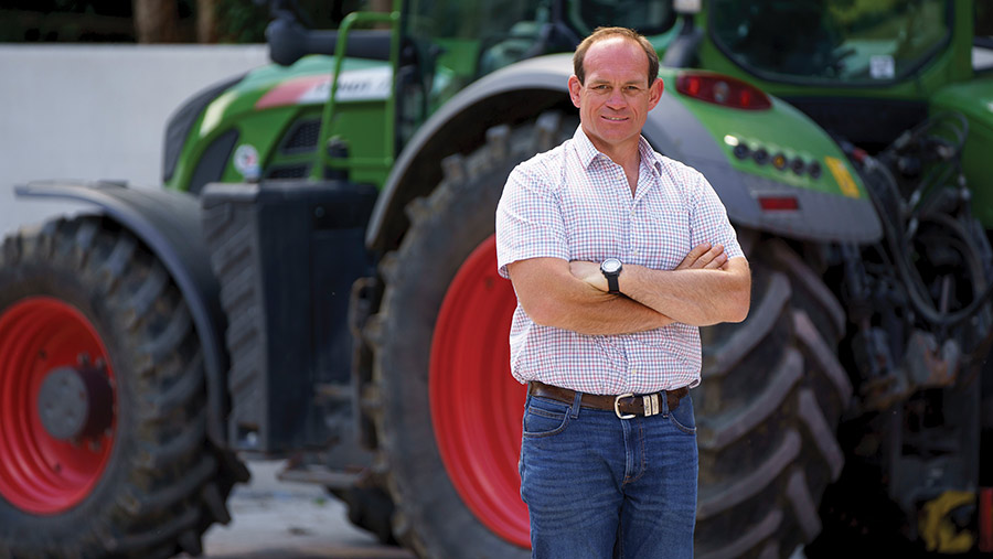 Man standing in front of a tractor