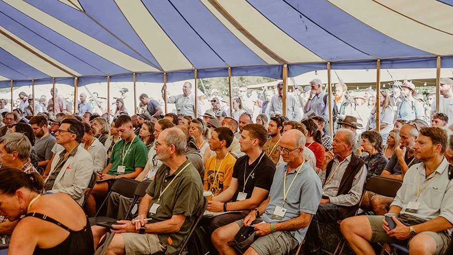 People sat on chairs under tent