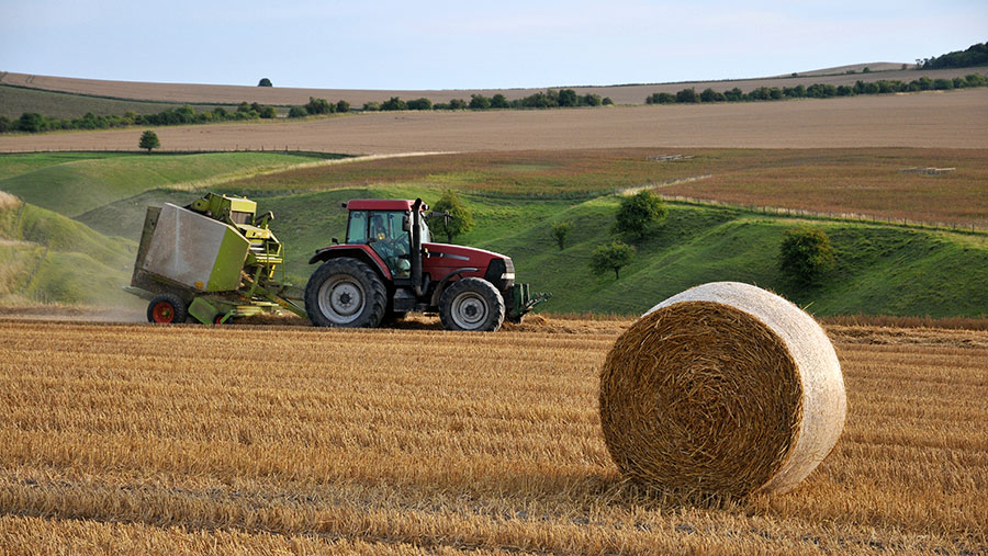 Tractor harvesting in field