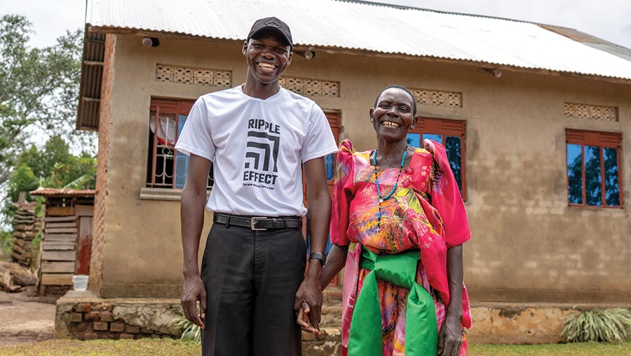 Robert Tamuzade and Lucy Nulale outside house in Uganda