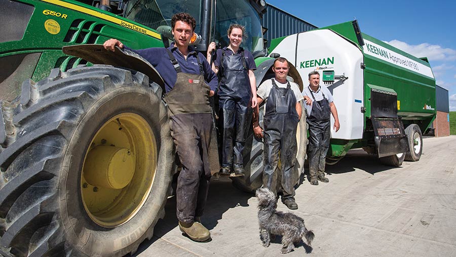 Workers in front of tractor