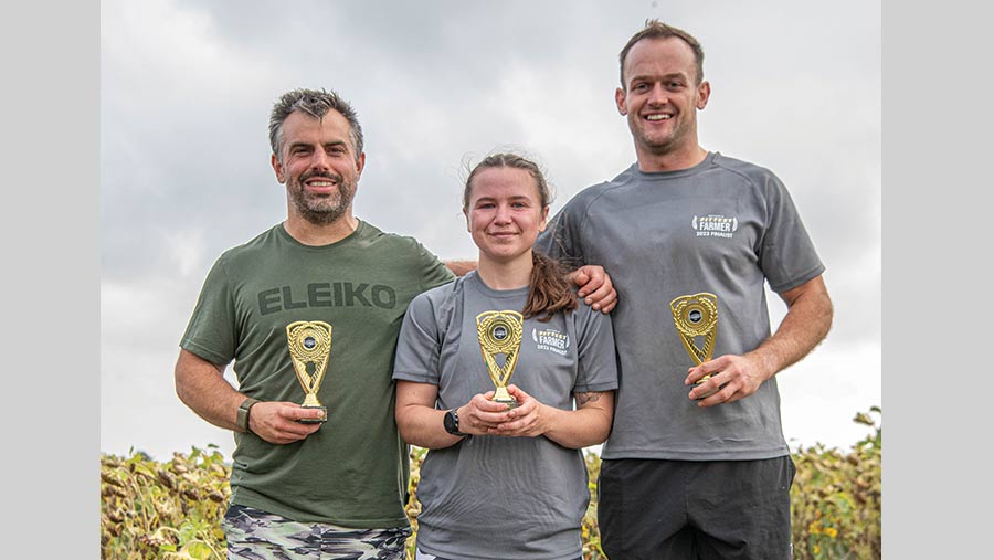 Two men and a woman with trophies