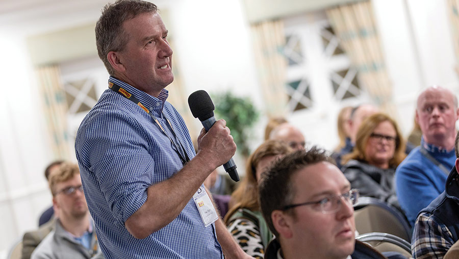 Man with a microphone asking a question