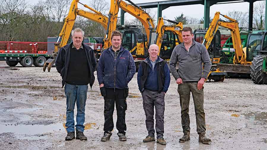 Farmers standing in front of a fleet of diggers