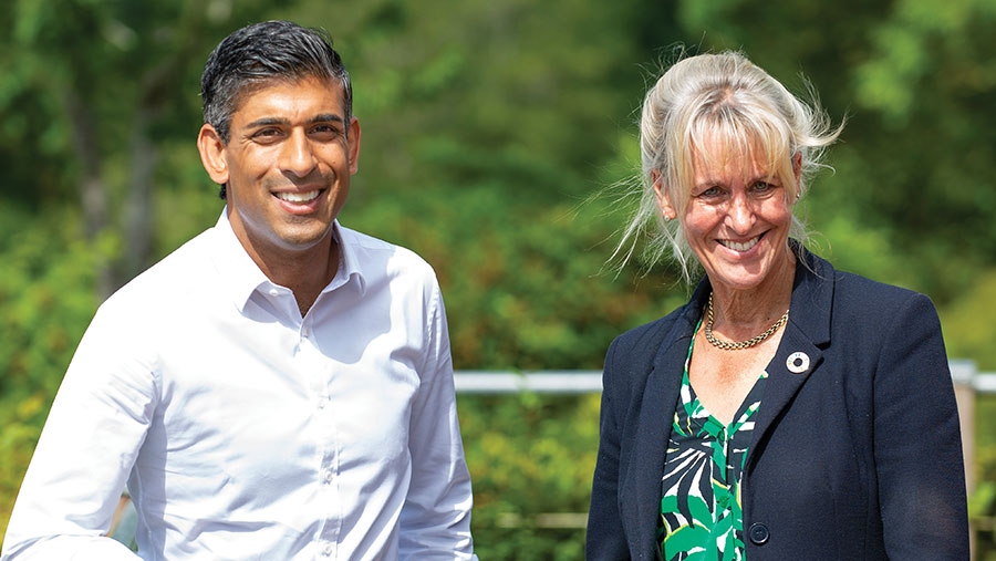 Two people smiling standing outdoors