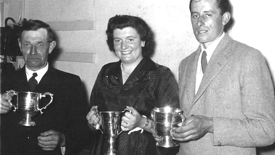 Jim Flay, Rosemary and Ivan Goff holding trophies for their farming achievements