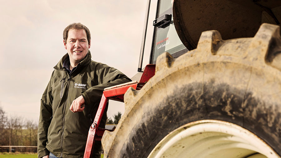 Scott Campbell standing next to a tractor