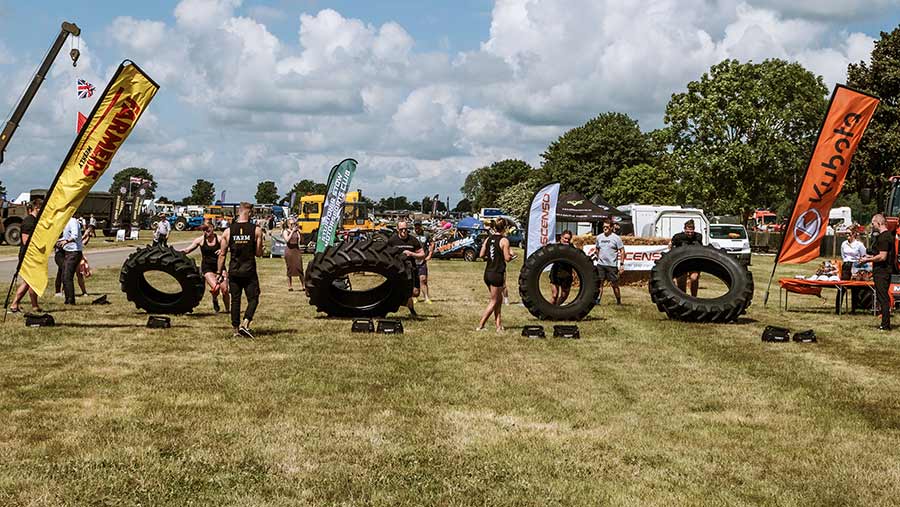 Britain's Fittest Farmer contestant lifting tyres