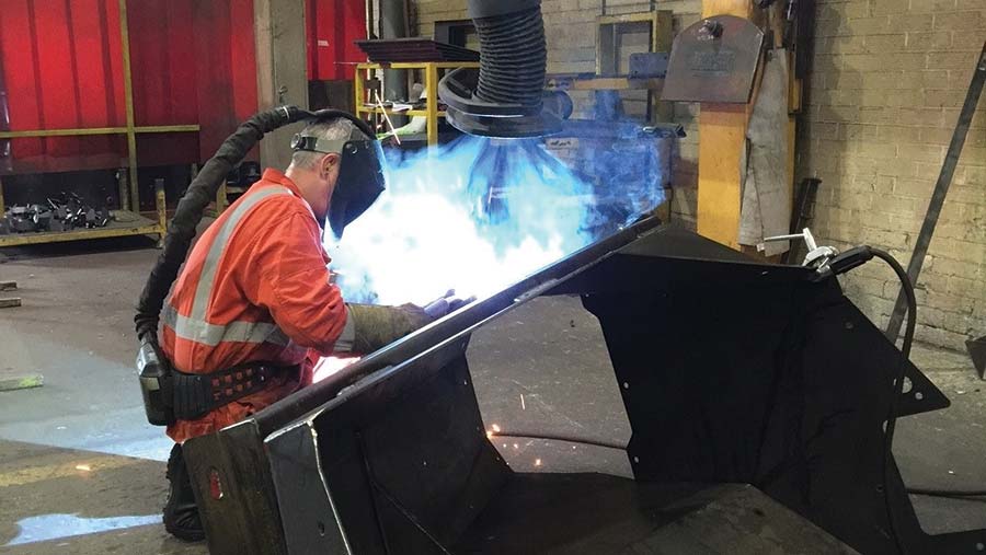 Welder at work with fume extractor