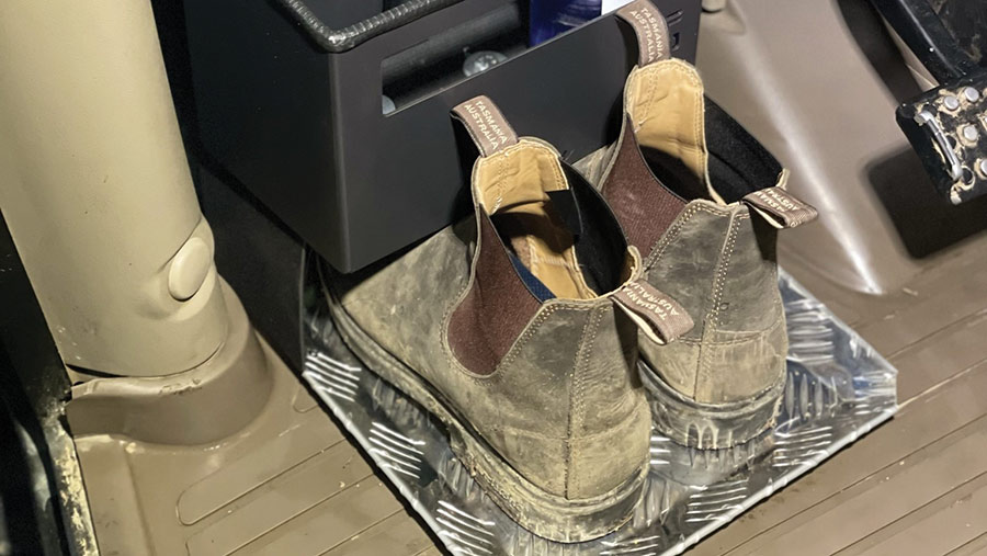 Work boots on a storage tray
