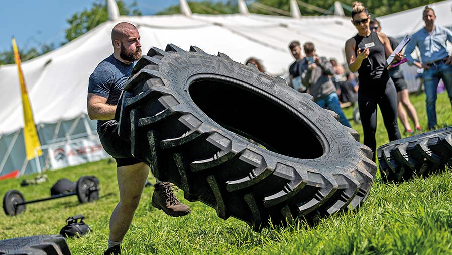 Britain's Fittest Farmer contestant lifting a tyre