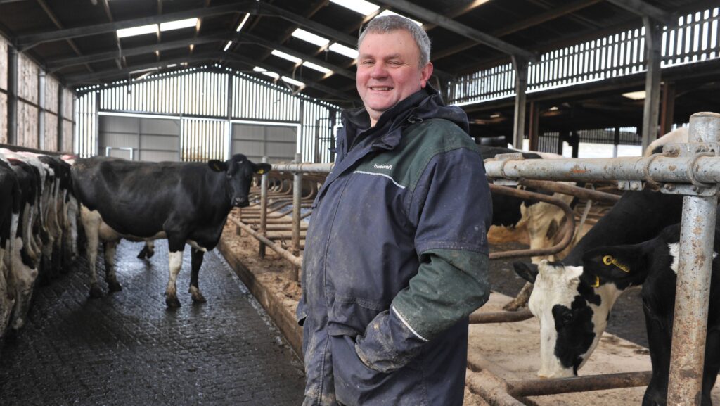 Martin Griffiths in a shed with dairy cows