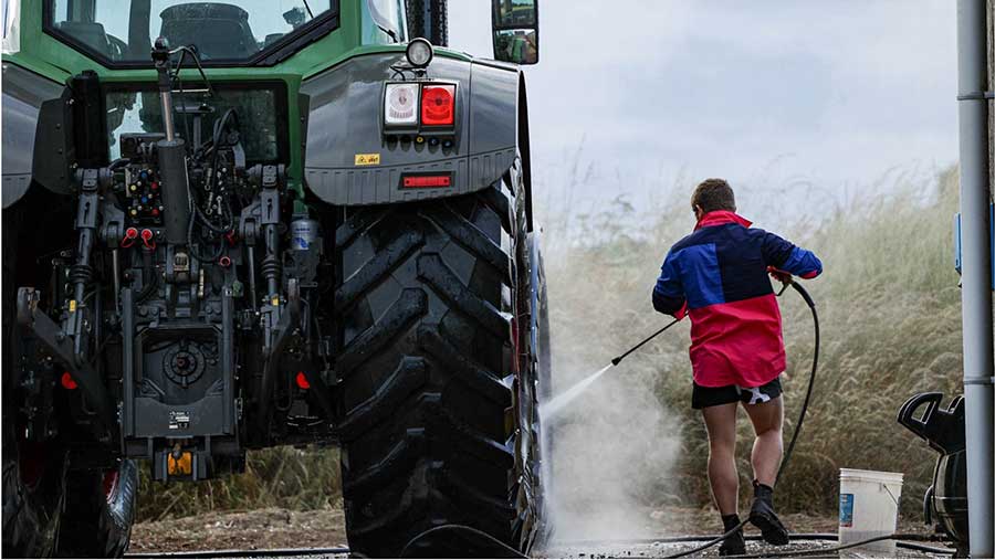 Person cleaning tractor