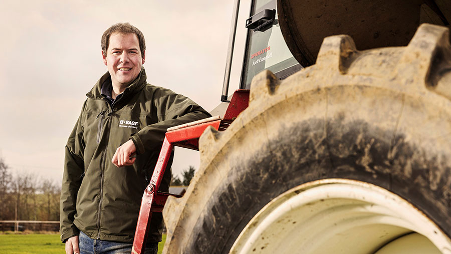Scott Campbell standing next to a tractor