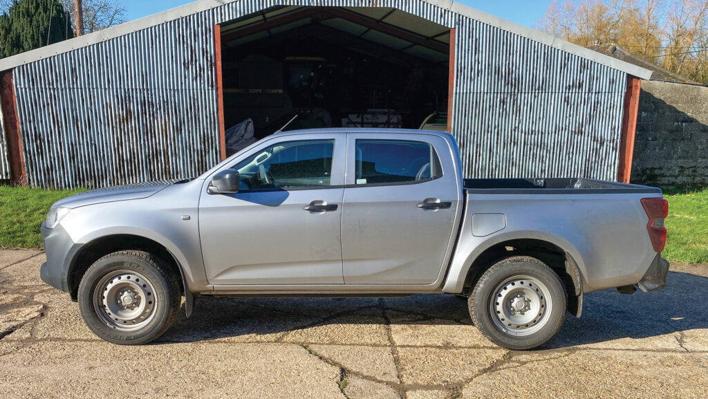 Isuzu D-Max Utility 4x4 parked outside a farm building