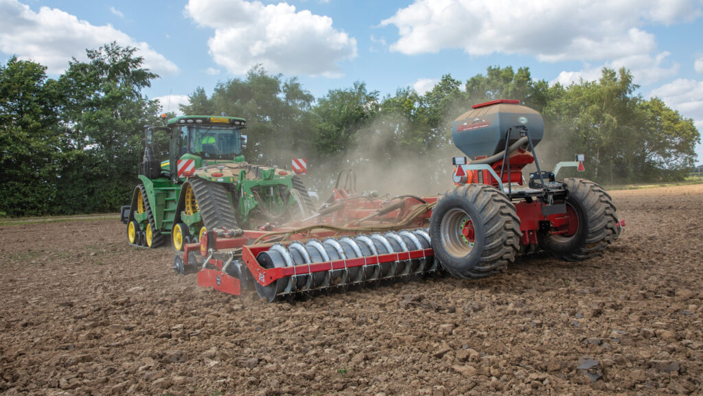 Tractor pulling subsoiler with seed hopper