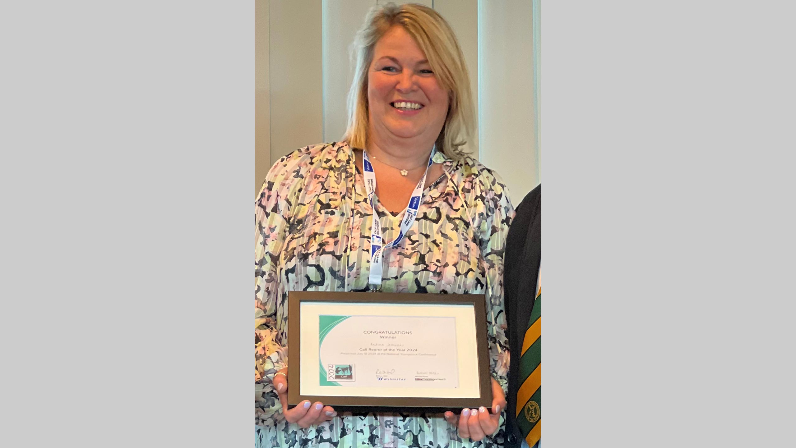 Woman holding an award certificate