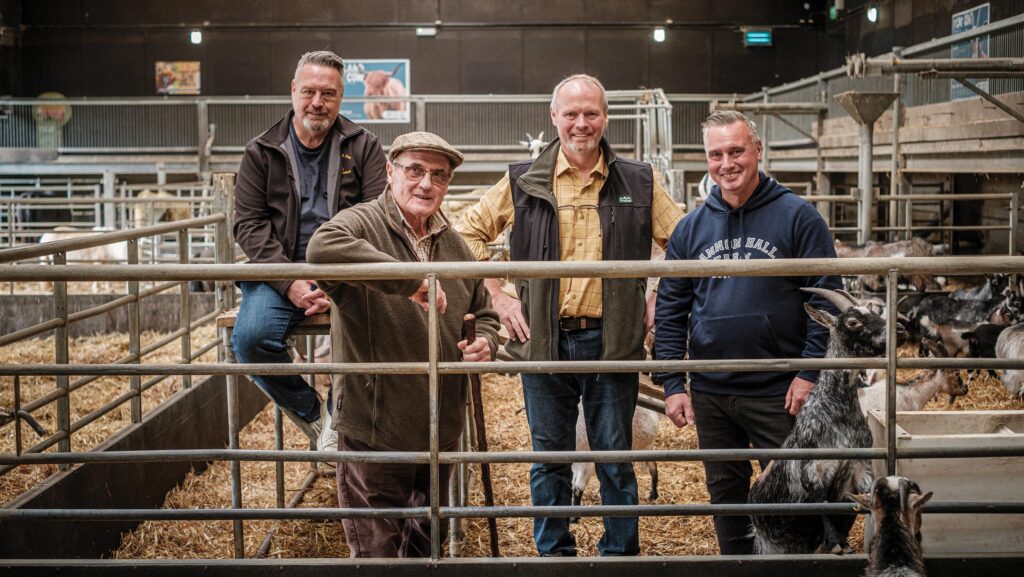 The Nicholson family posing in a cattle shed