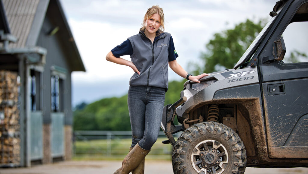 Ellie Lovell  standing beside an ATV