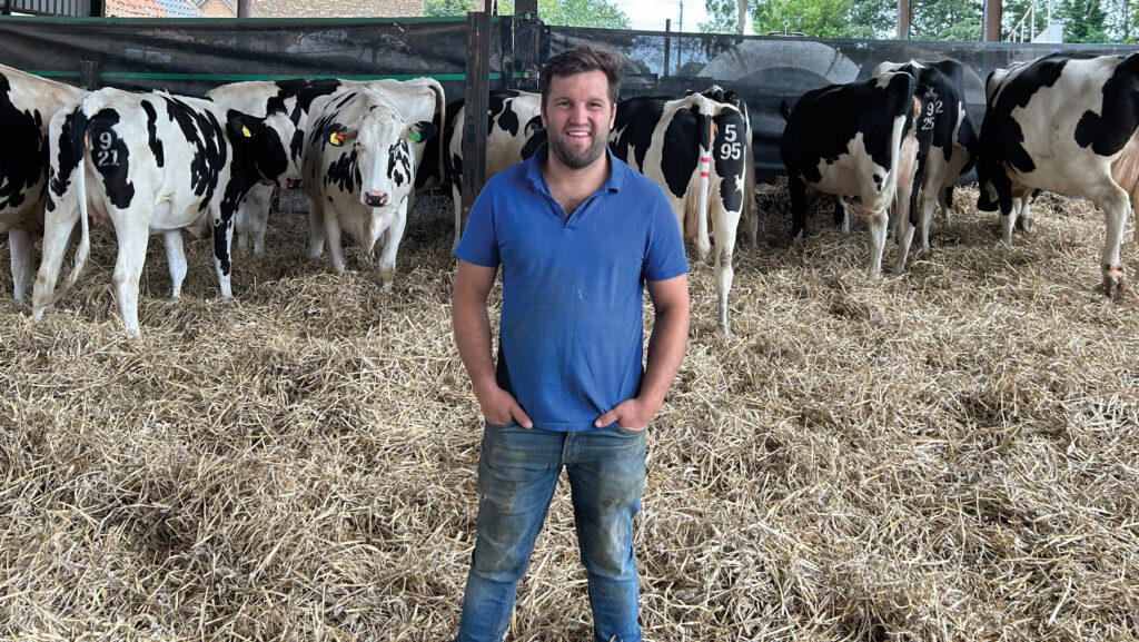 Farmer standing in cattle shed