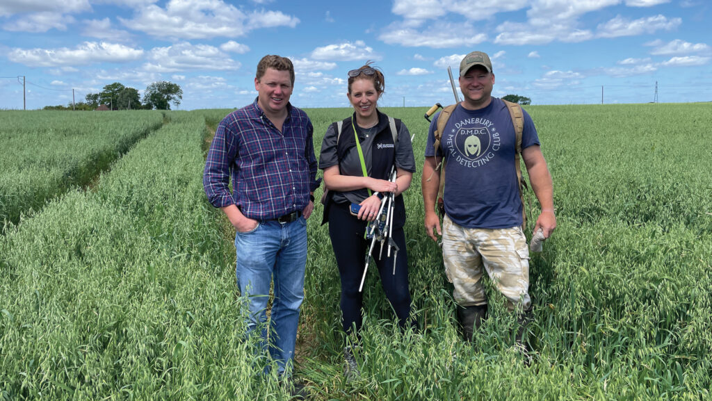 A group of three people in a field